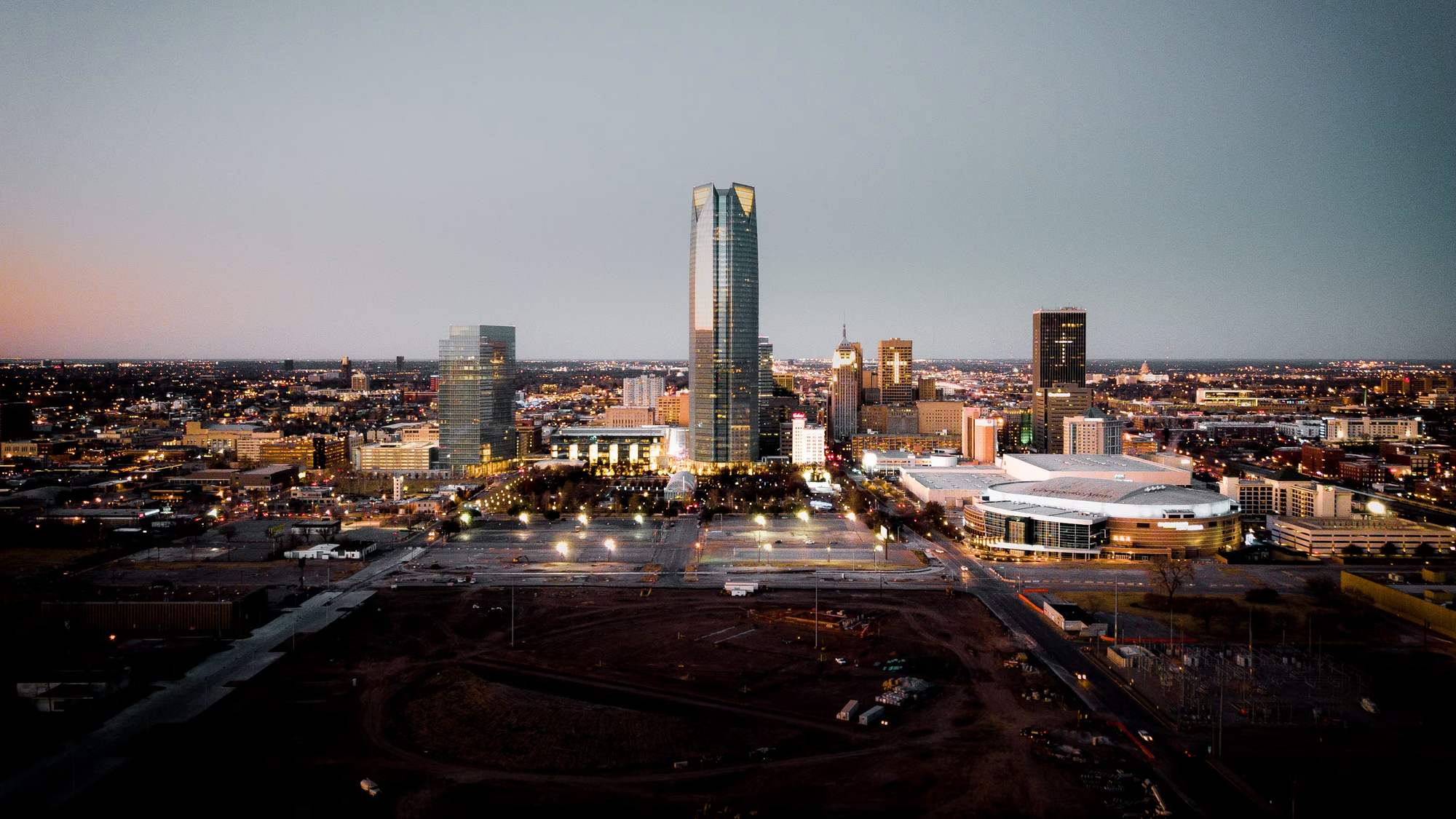 The downtown Oklahoma City skyline at dusk, seen from the west